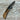 Folding knife with brown handle and black blade on a wooden surface