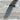 Folding knife with a brown handle on a wooden surface