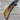 Folding knife with wooden handle on a wooden surface