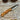Handcrafted Böhler N690 bushcraft knife with olive wood handle, leather sheath, and magnesium fire starter
