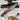 A hunting knife with a walnut handle and a stainless steel blade, accompanied by a brown leather sheath, placed on a wooden surface.