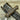 A hunting knife with a walnut handle and a stainless steel blade, accompanied by a brown leather sheath, placed on a wooden surface.